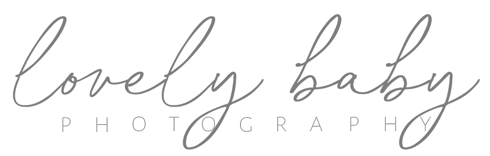 Logo with the words “lovely baby” in cursive script above “PHOTOGRAPHY” in uppercase block letters.